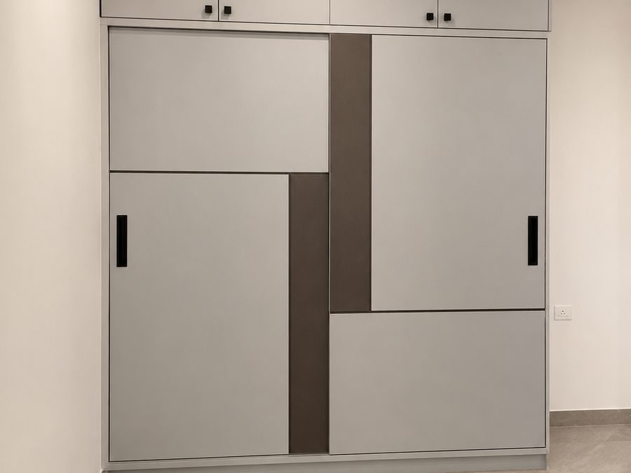 Sliding wardrobe with a geometric grey and brown design, Bengaluru interior by LuxeMorph Studios